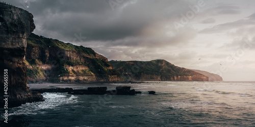 Amazing view of the sea and cliffs against the cloudy sky in the evening Fototapeta