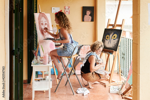 Mom and daughter painting in their art space photo