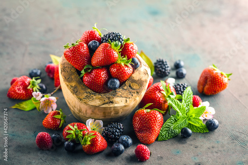 Berries colorful assorted mix of strawberry  blueberry  raspberry  blackberry on dark background