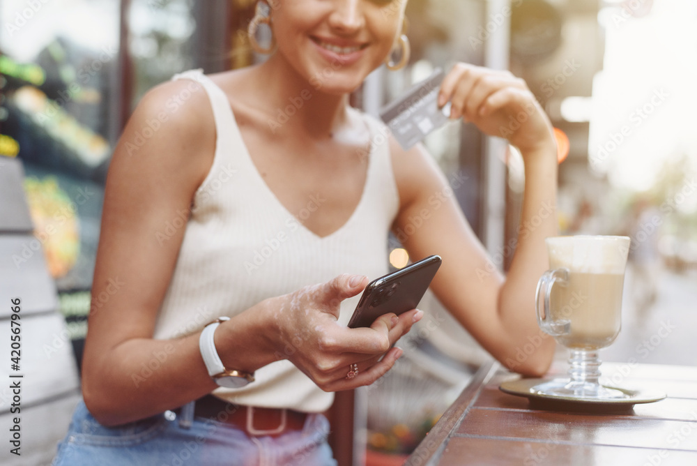 Smart phone online shopping in woman hand. Desk with coffee in background. Hands holding credit card and using mobile smart phone, Online shopping Smart phone online shopping in woman hand. Desk with coffee in background. Hands holding credit card and using mobile smart phone, Online shopping