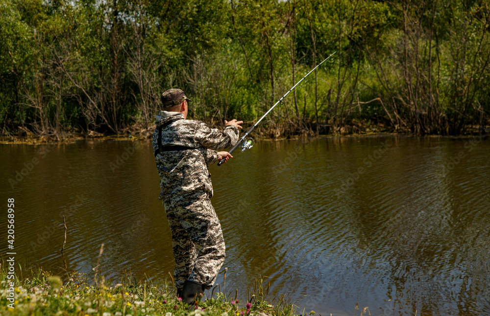 Unrecognizable angler casting rod in lake Unrecognizable angler casting rod in lake