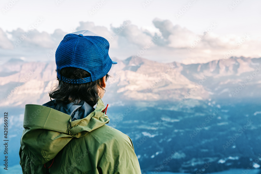 Cool Anonymous Male Hiker Watching Sunset over Swiss Alps Cool Anonymous Male Hiker Watching Sunset over Swiss Alps