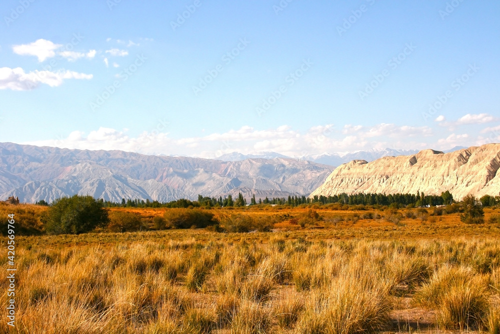 Beautiful mountains in Kyrgyzstan near Kazarman. Beautiful landscape with mountains at Kyrgyzstan on sunny day Beautiful mountains in Kyrgyzstan near Kazarman. Beautiful landscape with mountains at Kyrgyzstan on sunny day