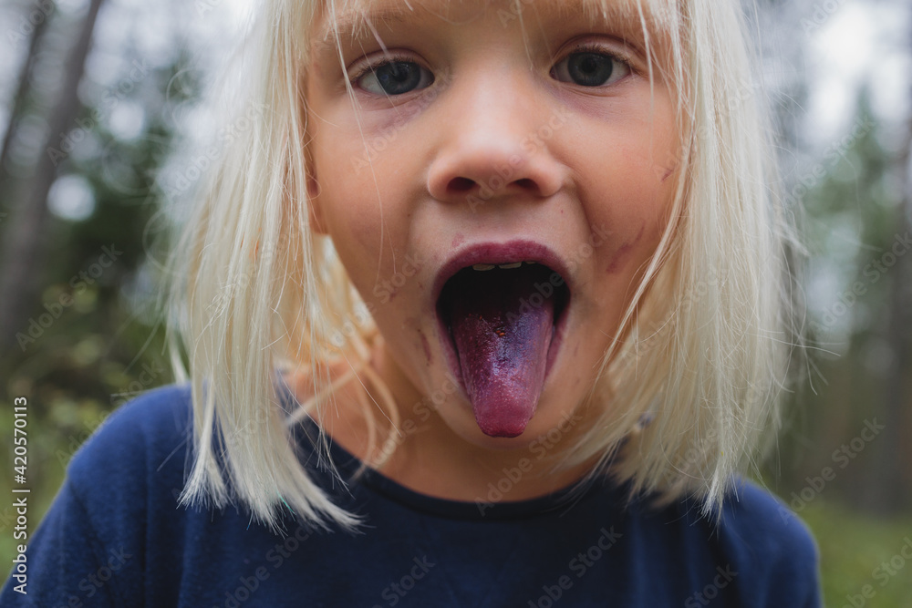 Tongue coloured with blueberries juice