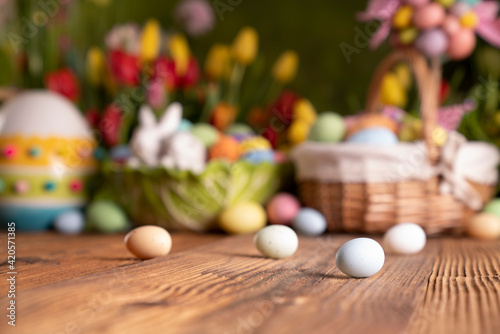 Easter theme. Easter eggs. Colorful tulips. Easter baskets. Rustic wooden table. 