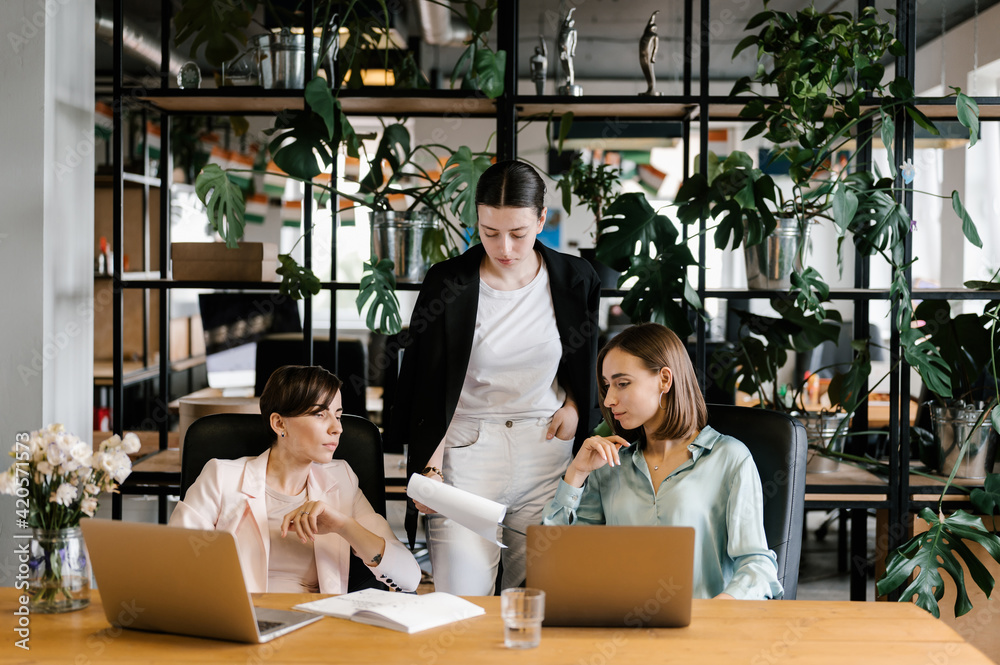 Woman showing papers to colleagues Woman showing papers to colleagues