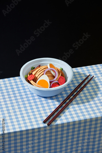 Bowl of asian noodle style soup with egg and tomato photo