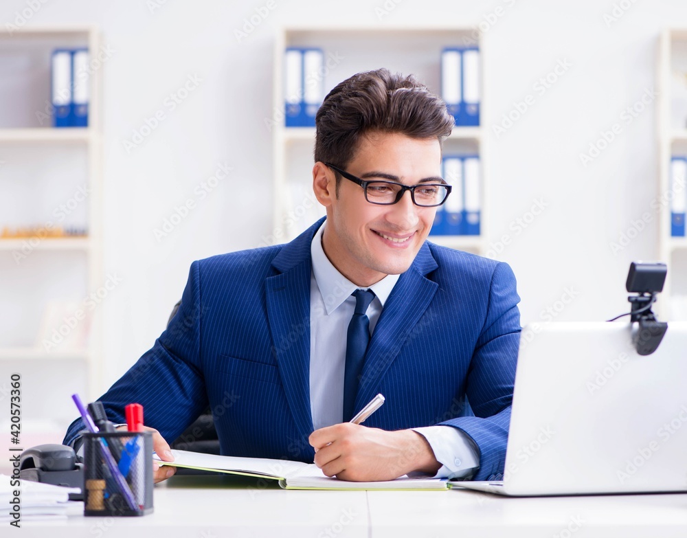 Young help desk operator working in office Young help desk operator working in office