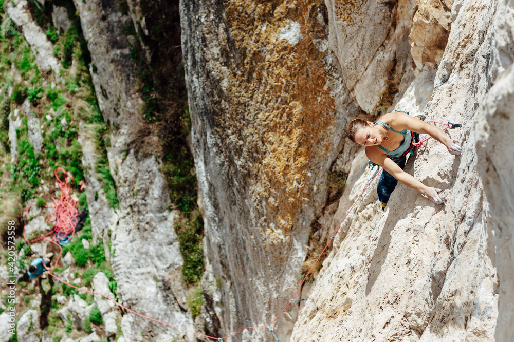 Young climber woman looking her next movement Young climber woman looking her next movement