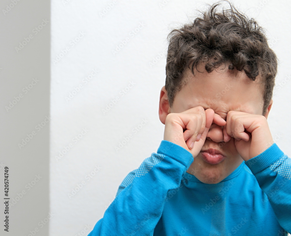 boy praying to God with hands held together with closed eyes on white background stock photo