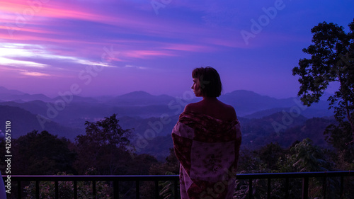 beautiful woman silhouete in kimono on scenery view of mountain photo