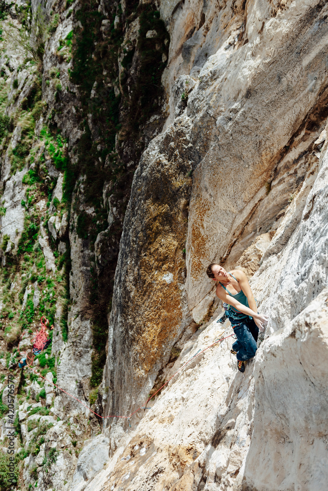Young climber woman looking her next movement Young climber woman looking her next movement