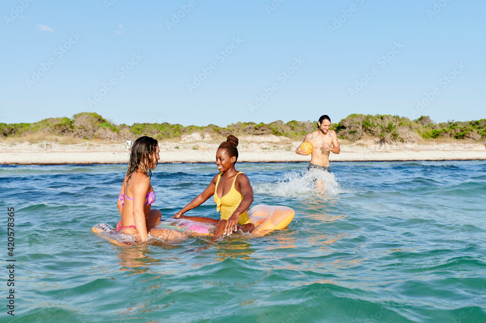Friends enjoying a day swimming at the beach Friends enjoying a day swimming at the beach