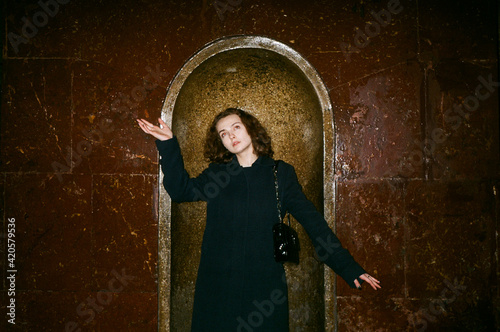 Portrait of a model inside the Moscow metro with a funny pose