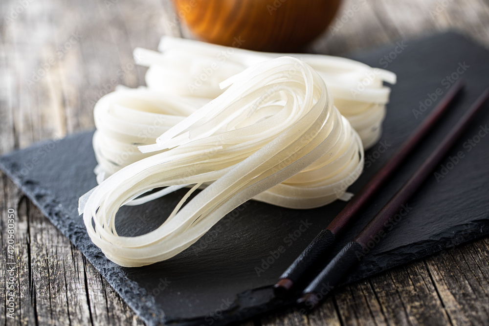 Dried white rice noodles. Raw pasta. Uncooked noodles. Dried white rice noodles. Raw pasta. Uncooked noodles.
