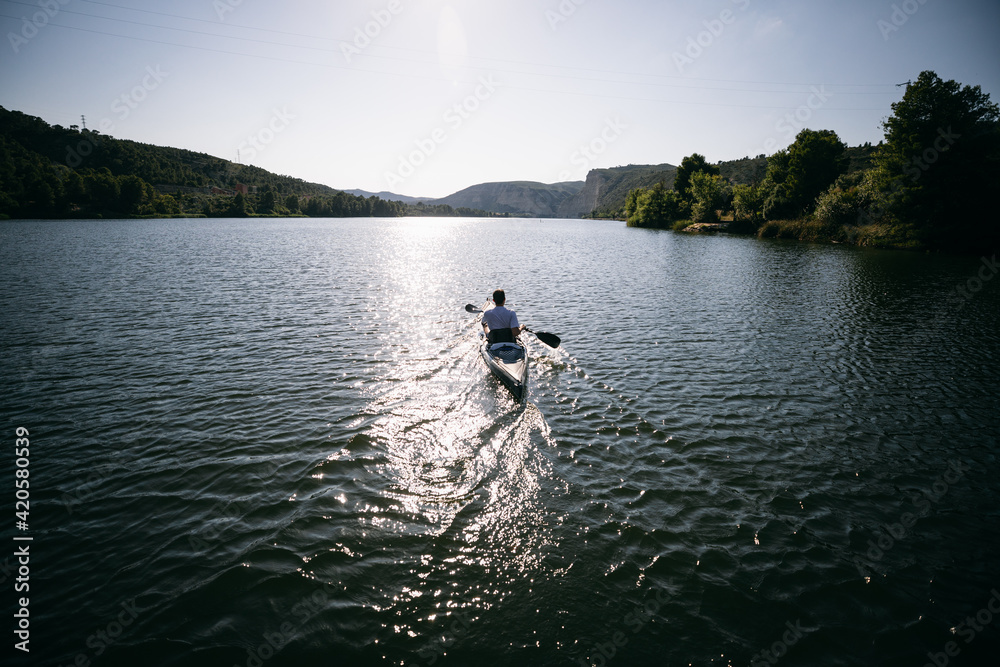 Unrecognizable male riding boat in morning Unrecognizable male riding boat in morning
