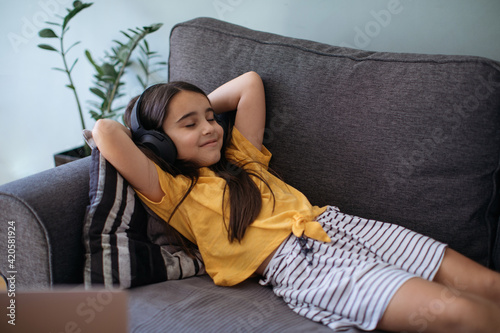 Schoolgirl Enjoying Music at her home photo