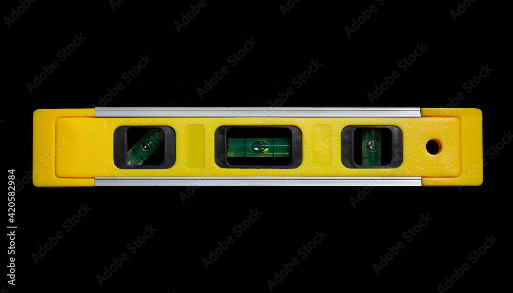Yellow building level on black isolated background is used in construction Yellow building level on black isolated background is used in construction