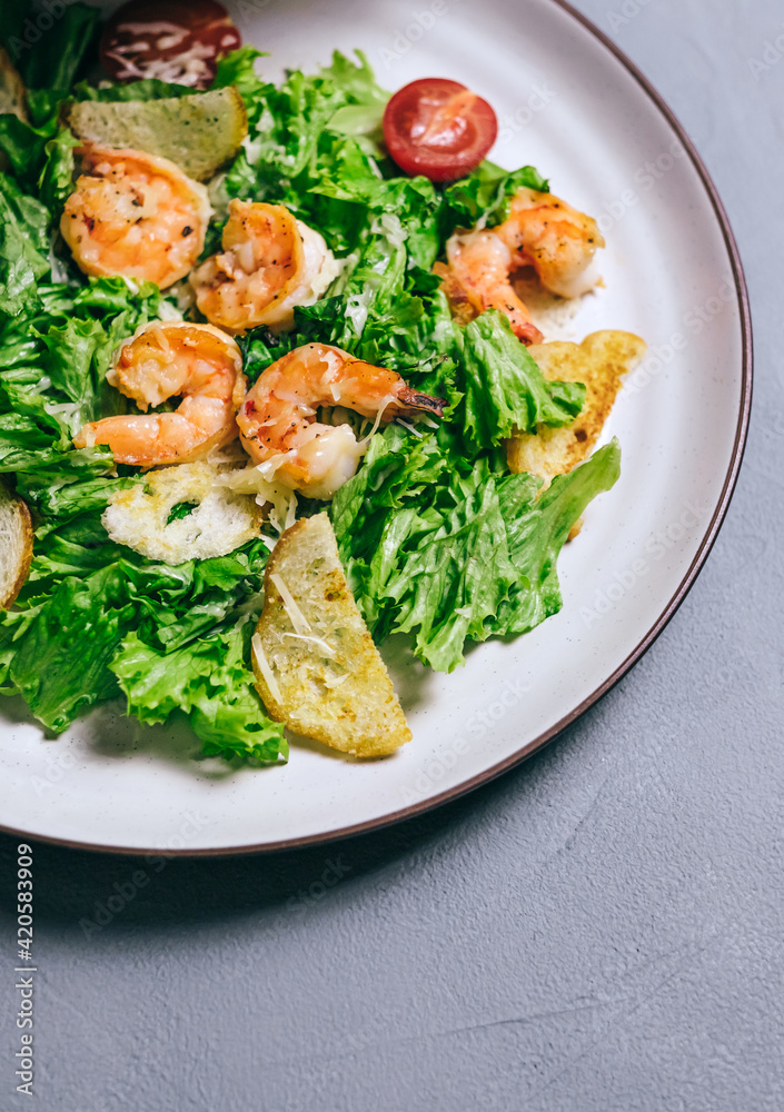 Fresh salad with shrimp, tomatoes and parmesan cheese in a plate, close-up. Healthy food Fresh salad with shrimp, tomatoes and parmesan cheese in a plate, close-up. Healthy food