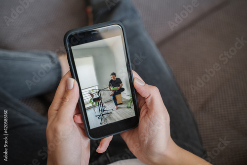 Woman Hands Holding Cellphone With Concert Online photo