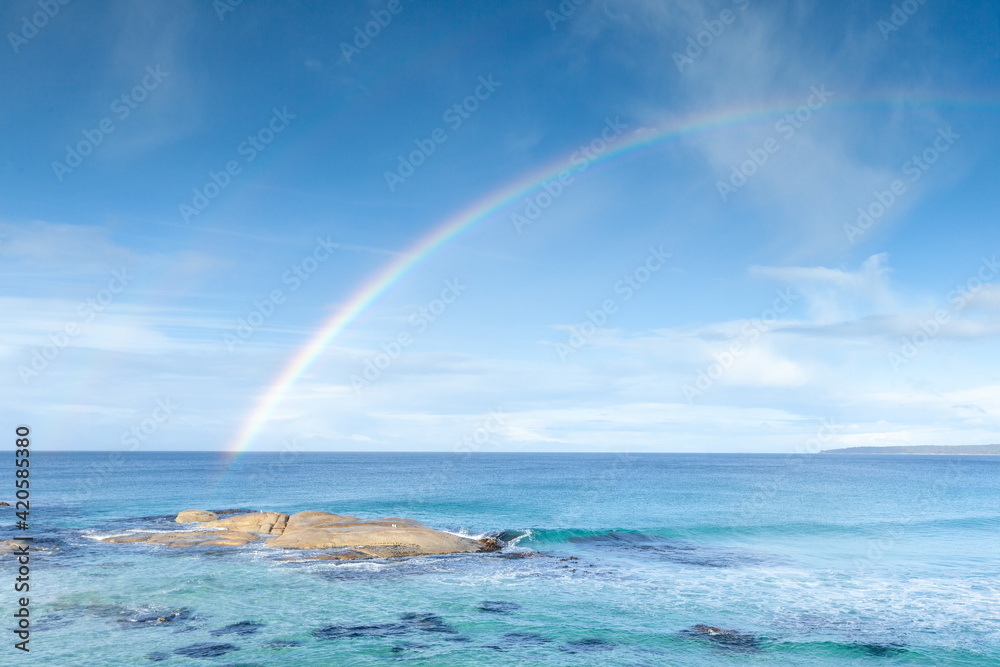 A rainbow over the Bay of Fires. Tasmania. Australia. A rainbow over the Bay of Fires. Tasmania. Australia.