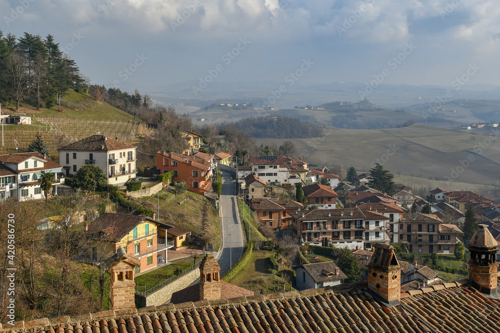 Fototapeta premium Elevated view of the old village of Monforte d'Alba, in the Langhe vineyard hills, Unesco World Heritage Site, in winter, Cuneo province, Piedmont, Italy