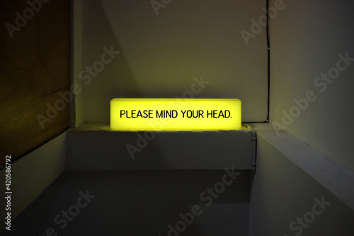 Please mind your head neon sign