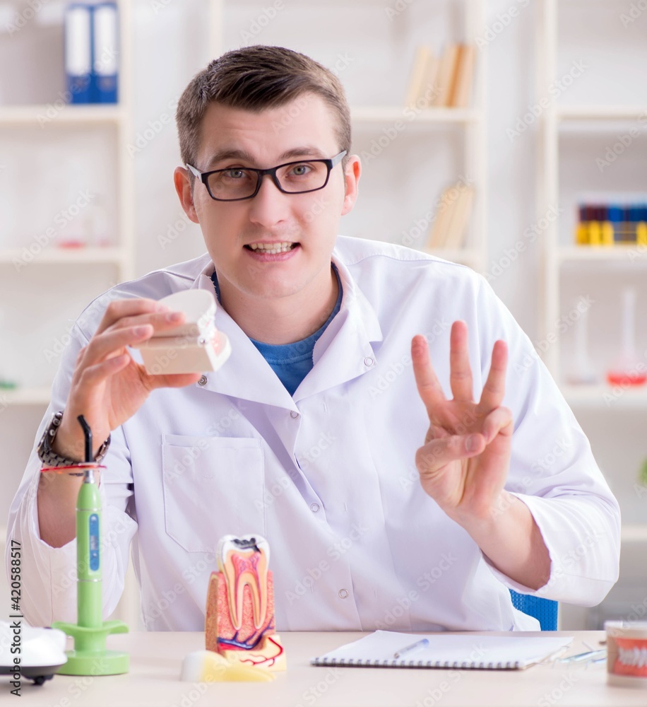 Dentist working teeth implant in medical lab Dentist working teeth implant in medical lab