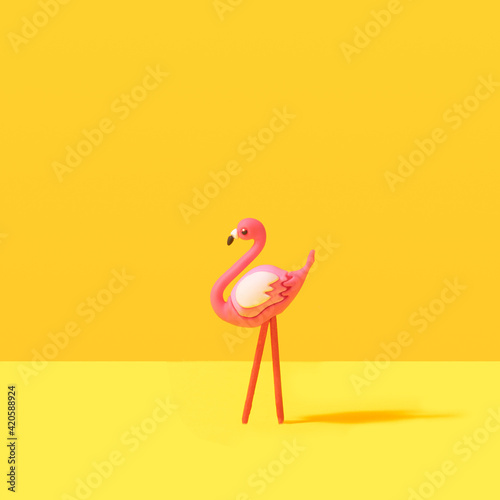 Minimal summer flamingo tropical concept. Illuminating yellow background.