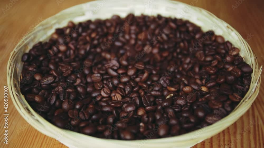 Roasted coffee beans fall into a bawl Roasted coffee beans fall into a bawl