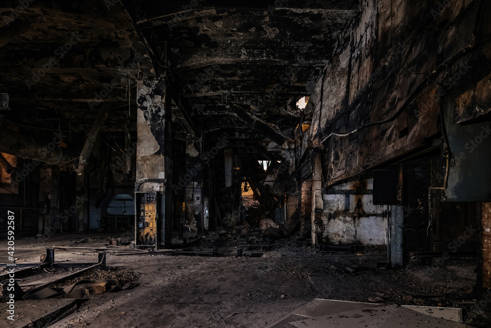 Burnt and ruined interior of industrial building after fire. Consequences of war, fire or other disaster