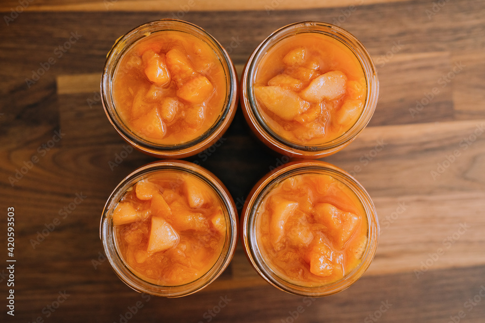 Woman preparing peach preserve Woman preparing peach preserve