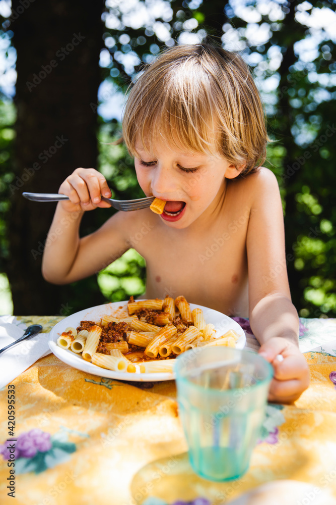 Little boy eating pasta Little boy eating pasta
