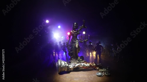 No law or dictatorship concept. The Statue of Justice with anti-riot police helmet holding scale. Creative artwork decoration with colorful toned foggy background. Selective focus photo