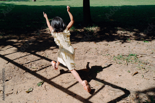 Little girl jumping in the shadow photo