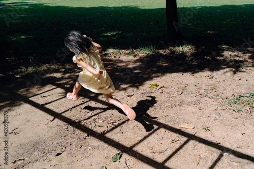 Little girl jumping in the shadow photo