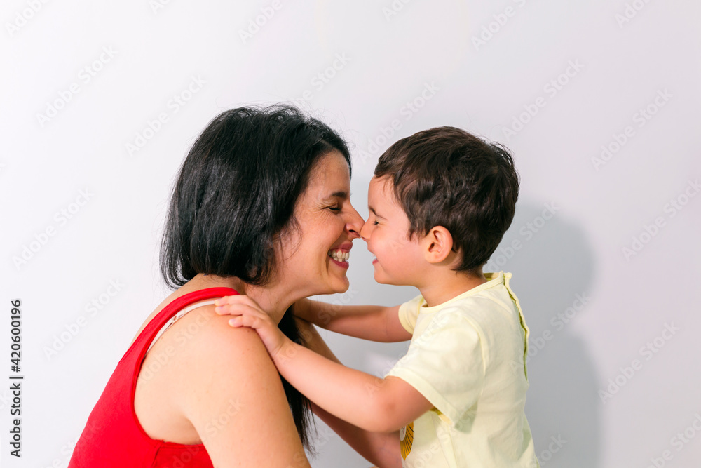 Mother and son kissing each other on the nose Mother and son kissing each other on the nose