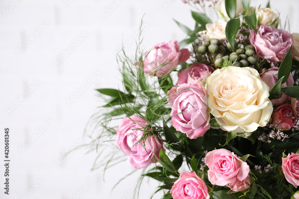Beautiful bouquet with roses on white background, closeup. Space for text
