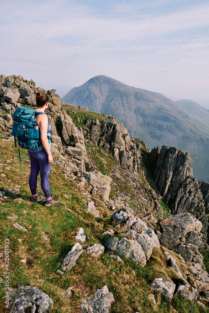 Female walker on Lingmell with Great Gable beyond. Lake District, Cumbria, UK. Female walker on Lingmell with Great Gable beyond. Lake District, Cumbria, UK.