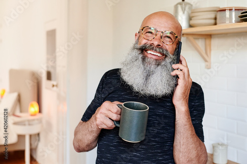 Laughing mature man talking on his phone