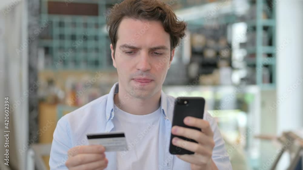 Portrait of Young Man with Successful Online Payment on Smartphone Portrait of Young Man with Successful Online Payment on Smartphone