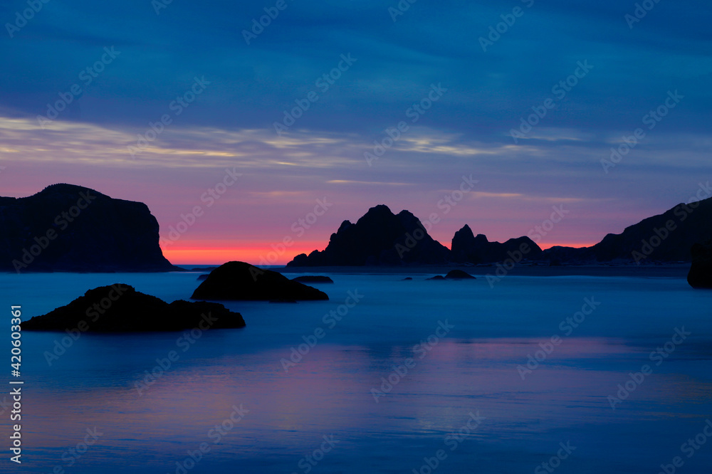 USA, Oregon, Bandon. Sunset on beach sea stacks.