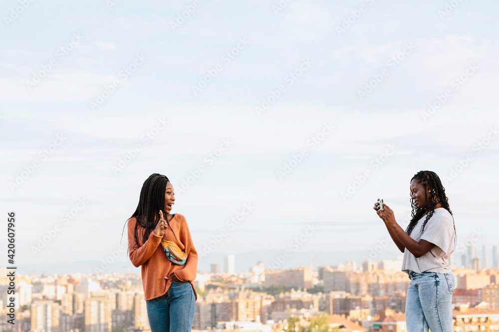 © Jimena Roquero/Stocksy - Two young woman taking pictures to each other © Jimena Roquero/Stocksy - Two young woman taking pictures to each other