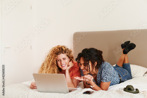 Smiling friends watching videos online