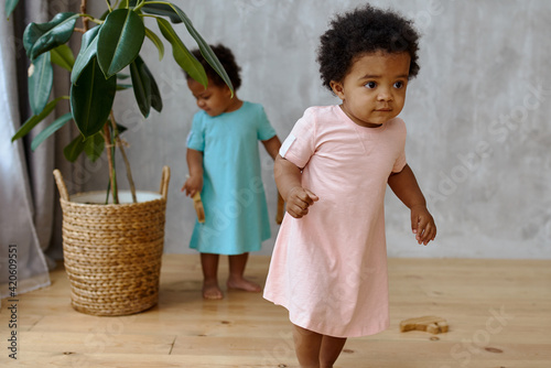 two twin girls play with each other. child at home. photo