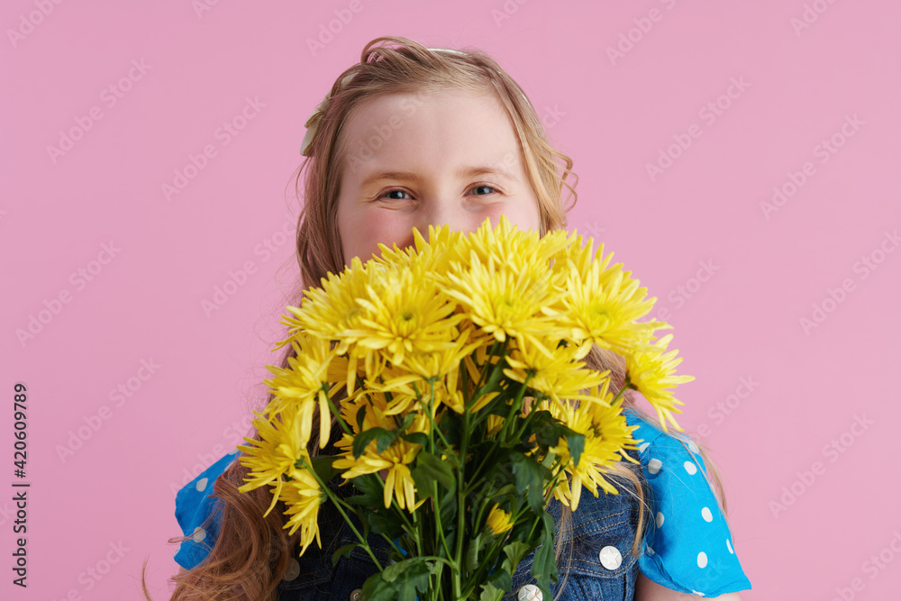 happy stylish girl in dotted blue overall on pink