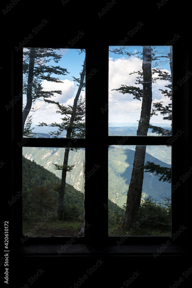 Closed window overlooking mountains Closed window overlooking mountains