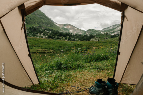 The view from the tent with hiking shoes photo