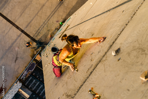 Female climber hanging on wall photo