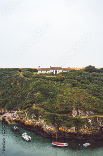 Traditional Welsh cottage overlooking a harbour. Porth Clais, Wales. photo